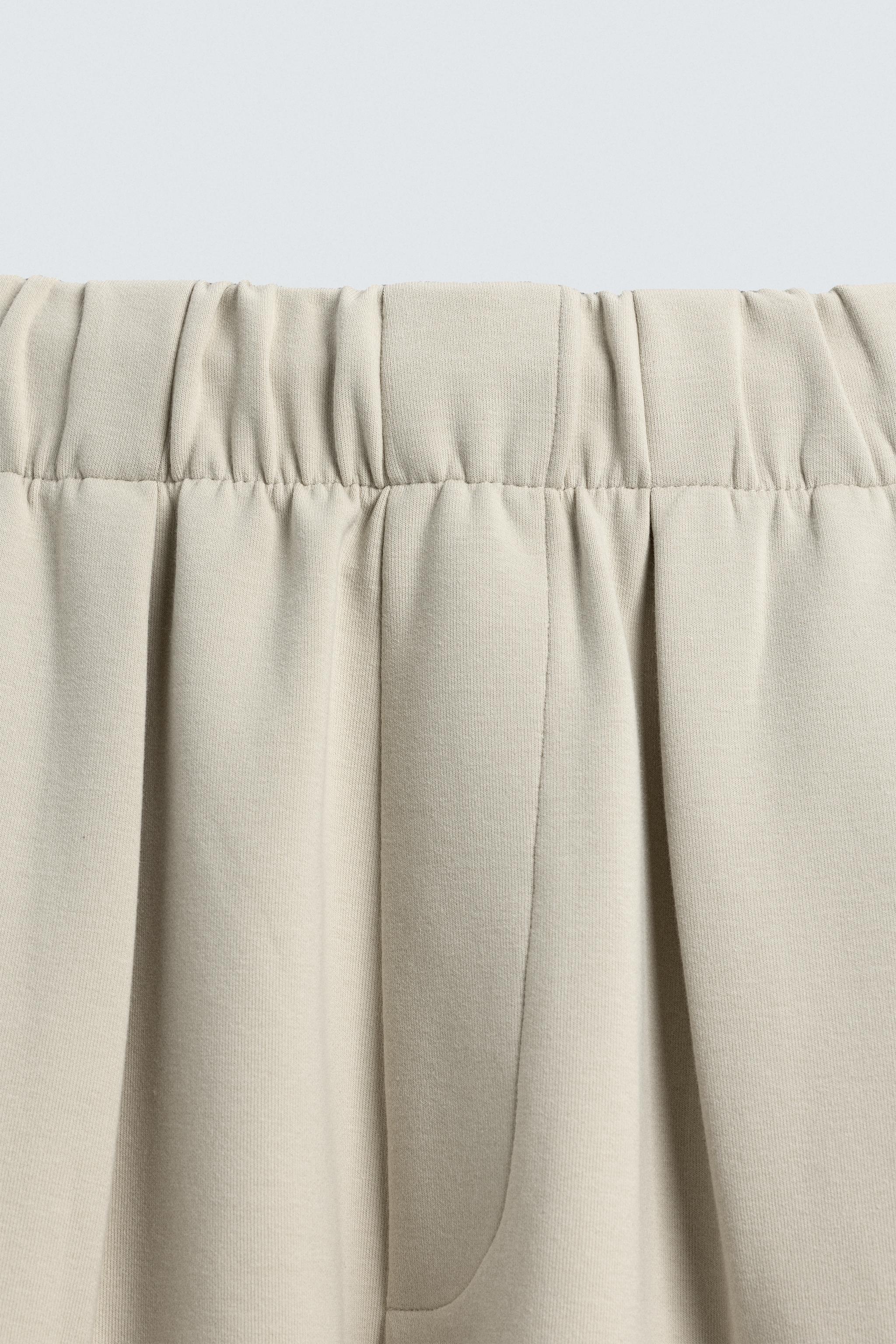 INTERLOCK PLEATED PANTS